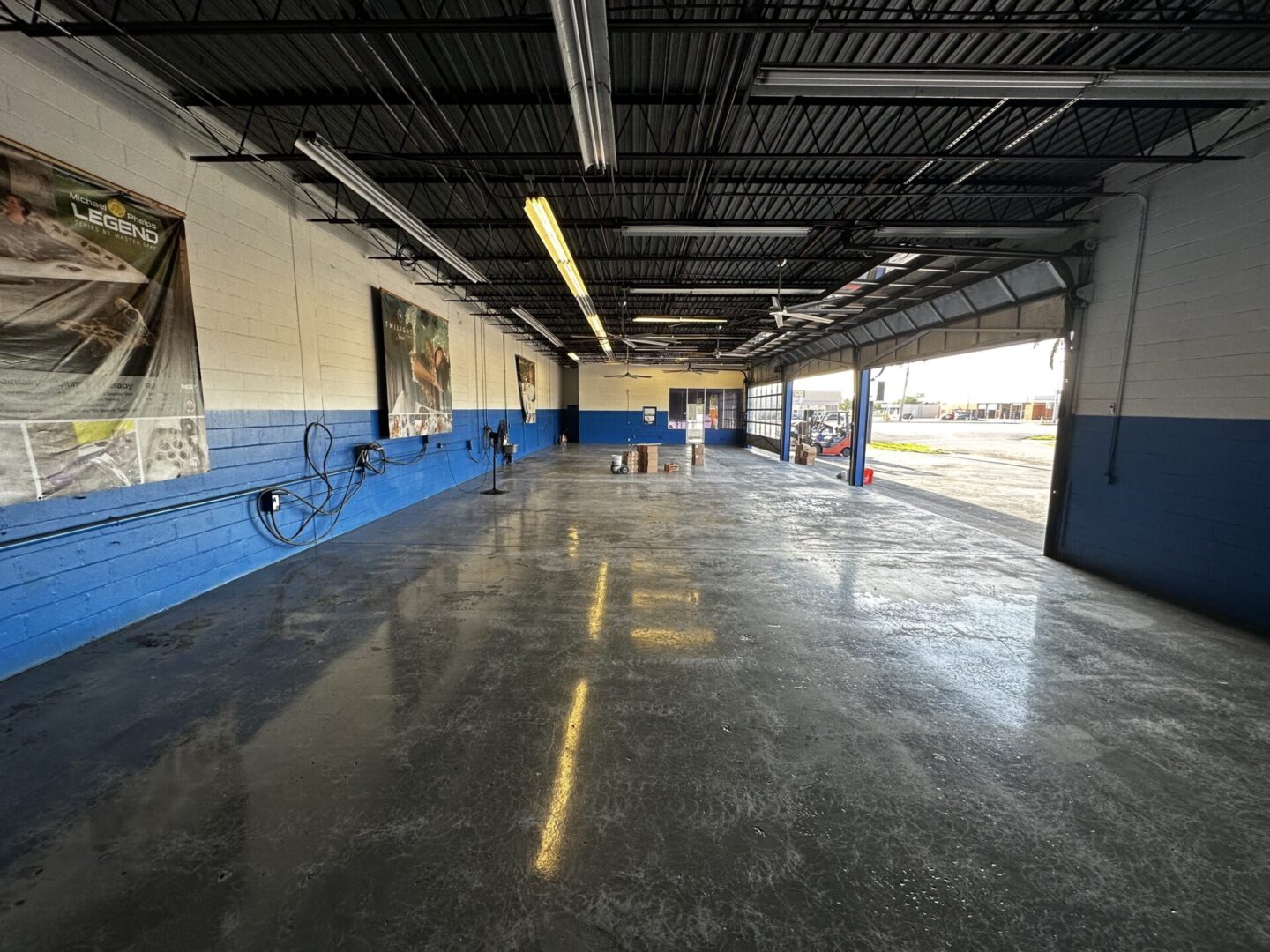 A large empty parking garage with blue walls.