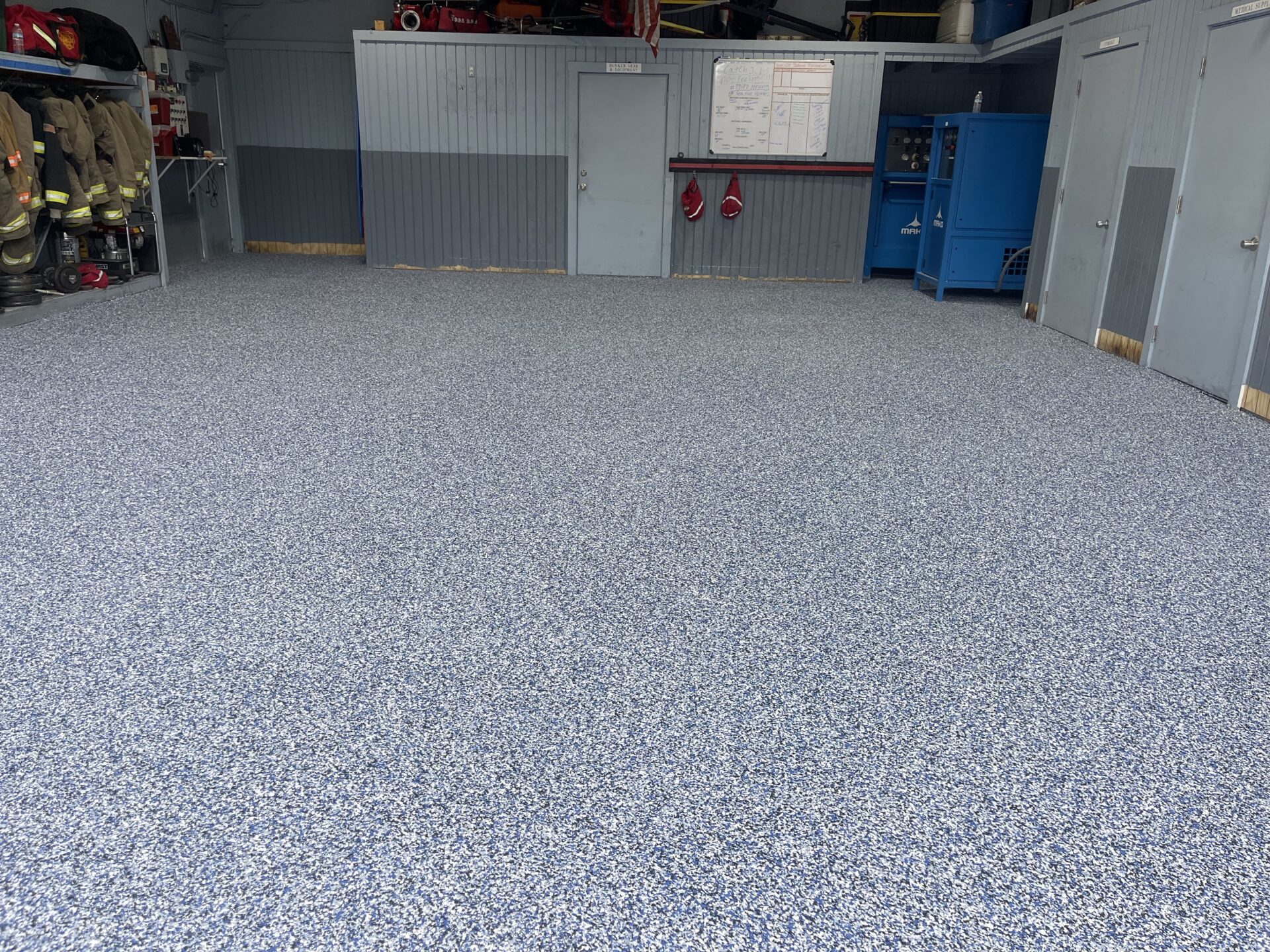 A garage floor with blue and white speckles.