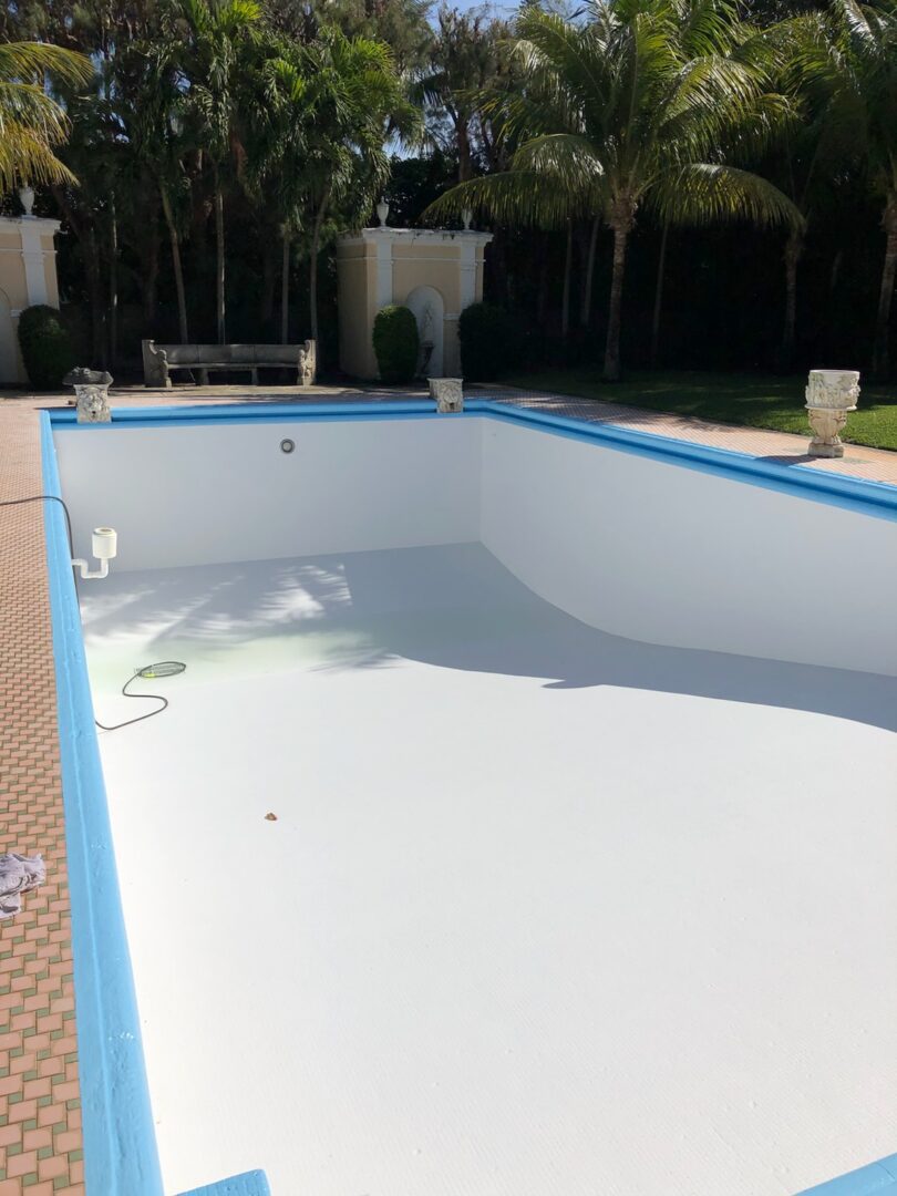 A pool that has been painted white and blue.